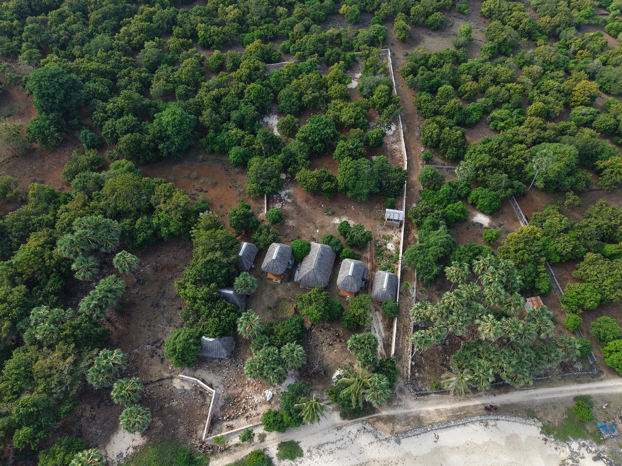 Overhead view of the existing bungalows and walled boundary within the plot