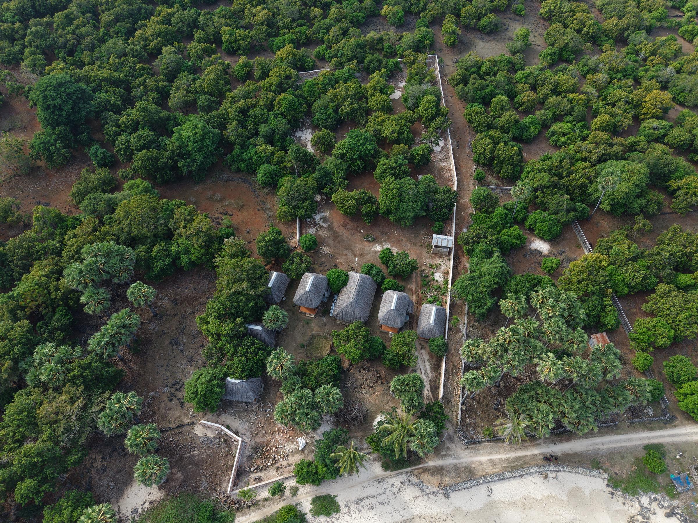 Overhead view of the existing bungalows and walled boundary within the plot